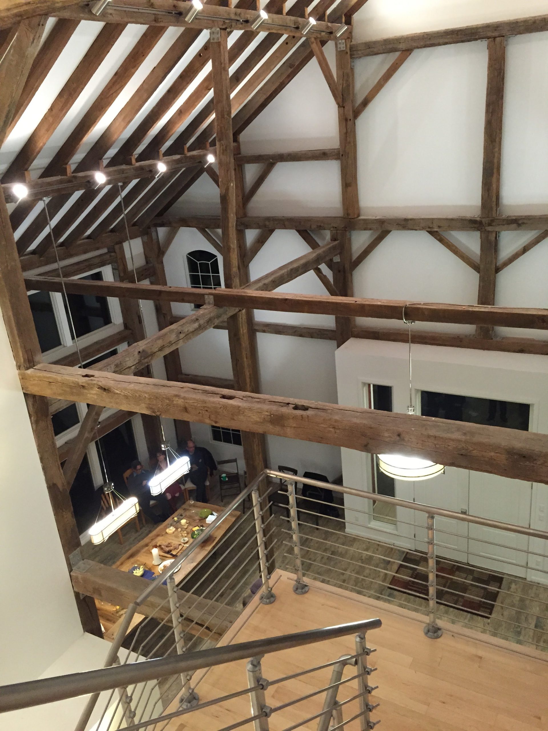 Exposed timber frame inside a repurposed barn by Kurt J. Ludwig, AIA